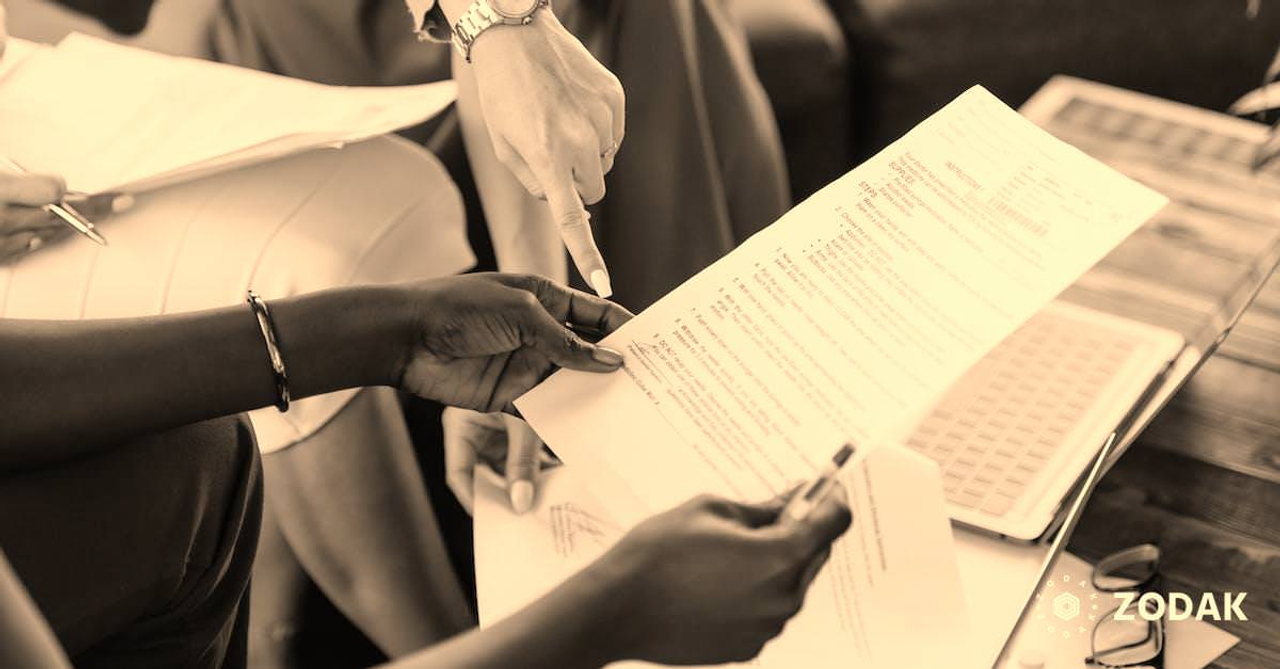 Multiethnic businesswomen checking information in documents