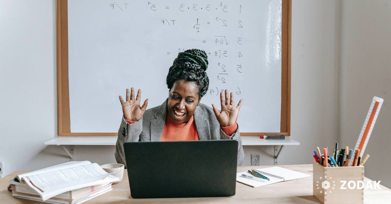 Happy black woman using laptop for online work