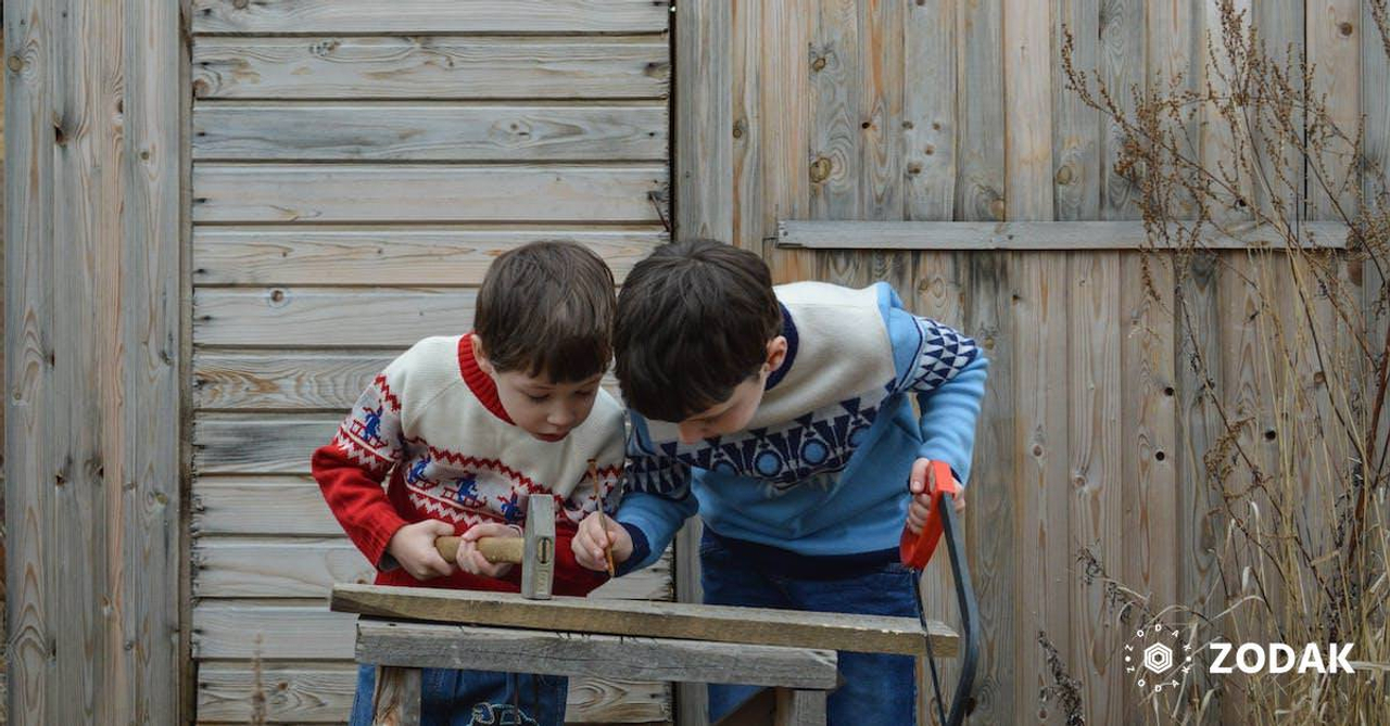 Children learning how to use hammer