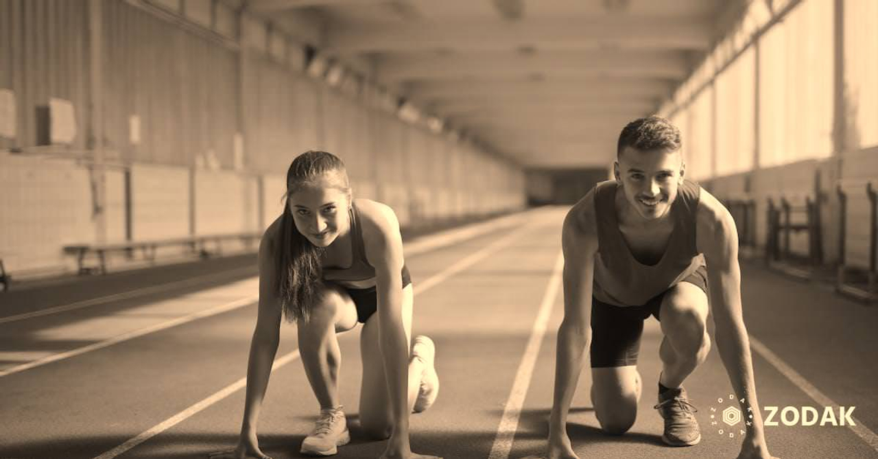 Men and Woman in Red Tank Top is Ready to Run on Track Field