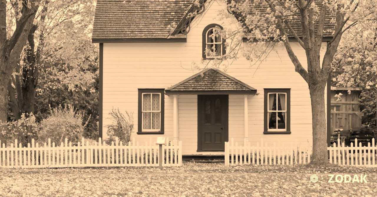 White and Red Wooden House With Fence