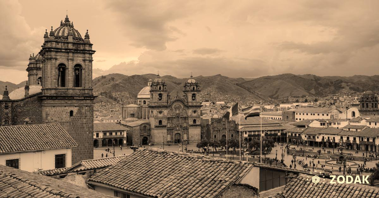 Cityscape of medieval church and houses with old tile roof in Cusco Peru