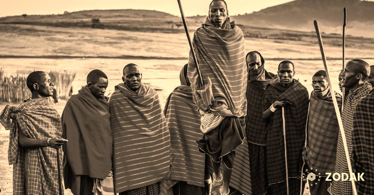 Photo of Group of Men Wearing Assorted Scarves Holding Sticks