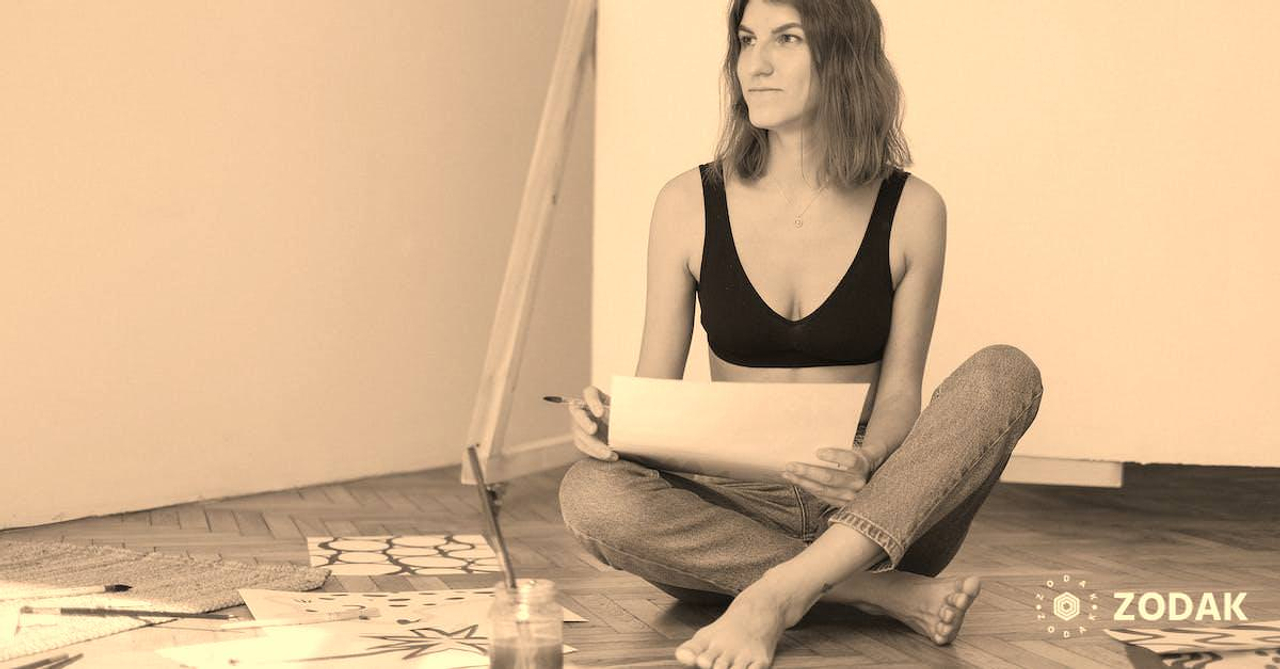 Photo of Woman Sitting on Floor While Looking Serious