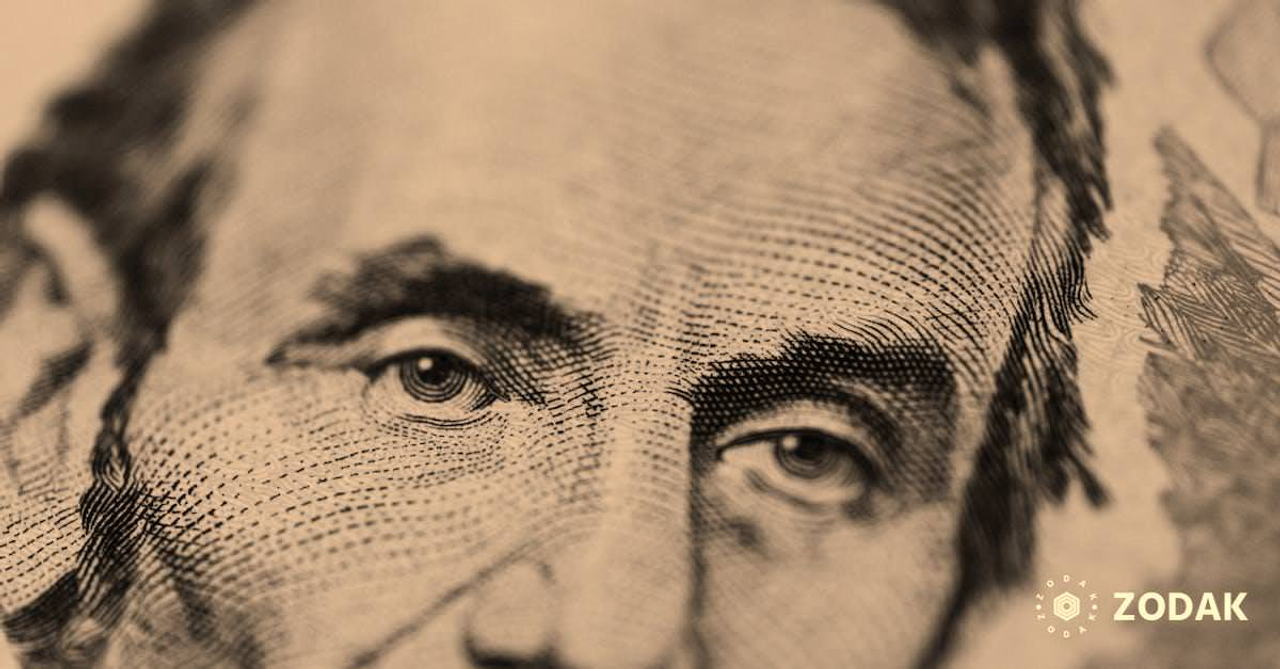 Closeup of male American president printed on five dollar bill and looking away pensively