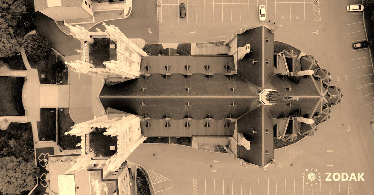 Drone view of roof of high building of educational institution complex located in downtown of USA