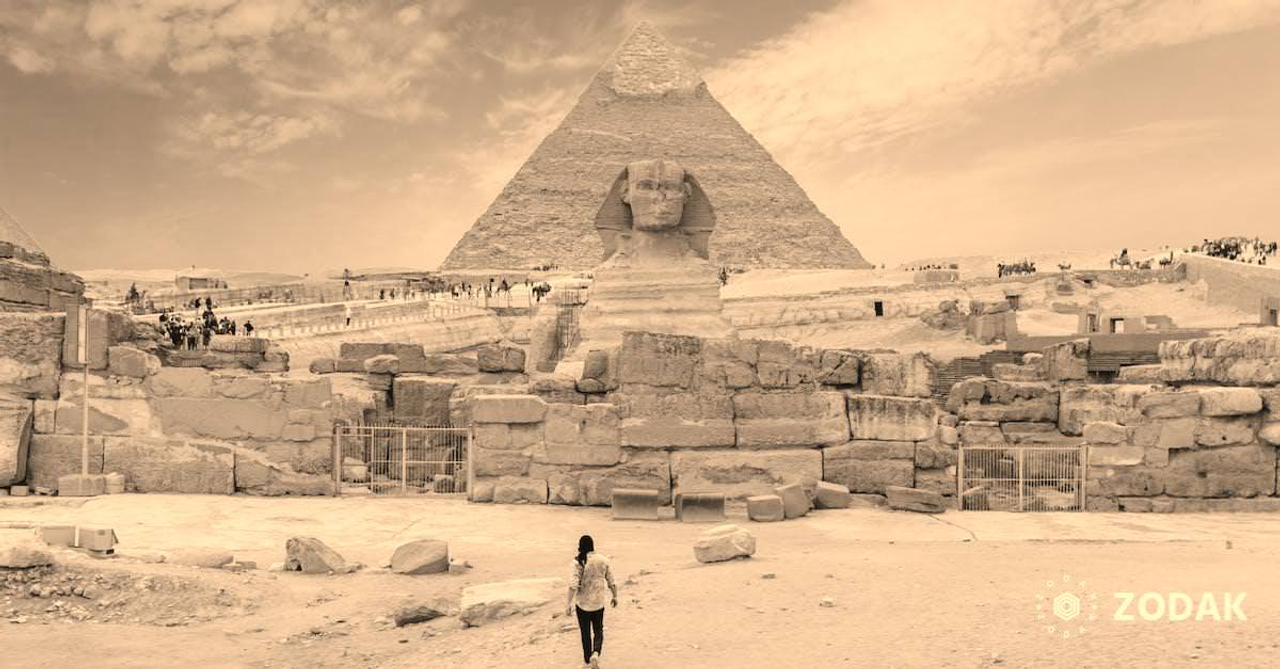 Back view of unrecognizable man walking towards ancient monument Great Sphinx of Giza