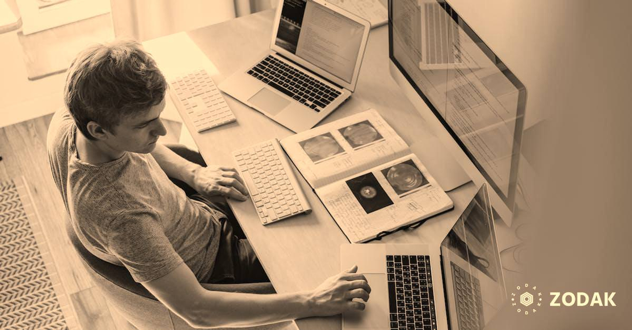 Man Using 3 Computers