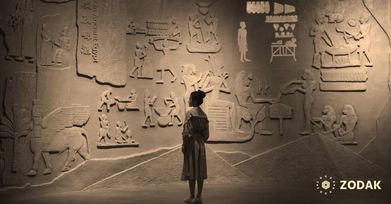 Back view of anonymous female traveler standing near ancient wall with Egyptian engraving