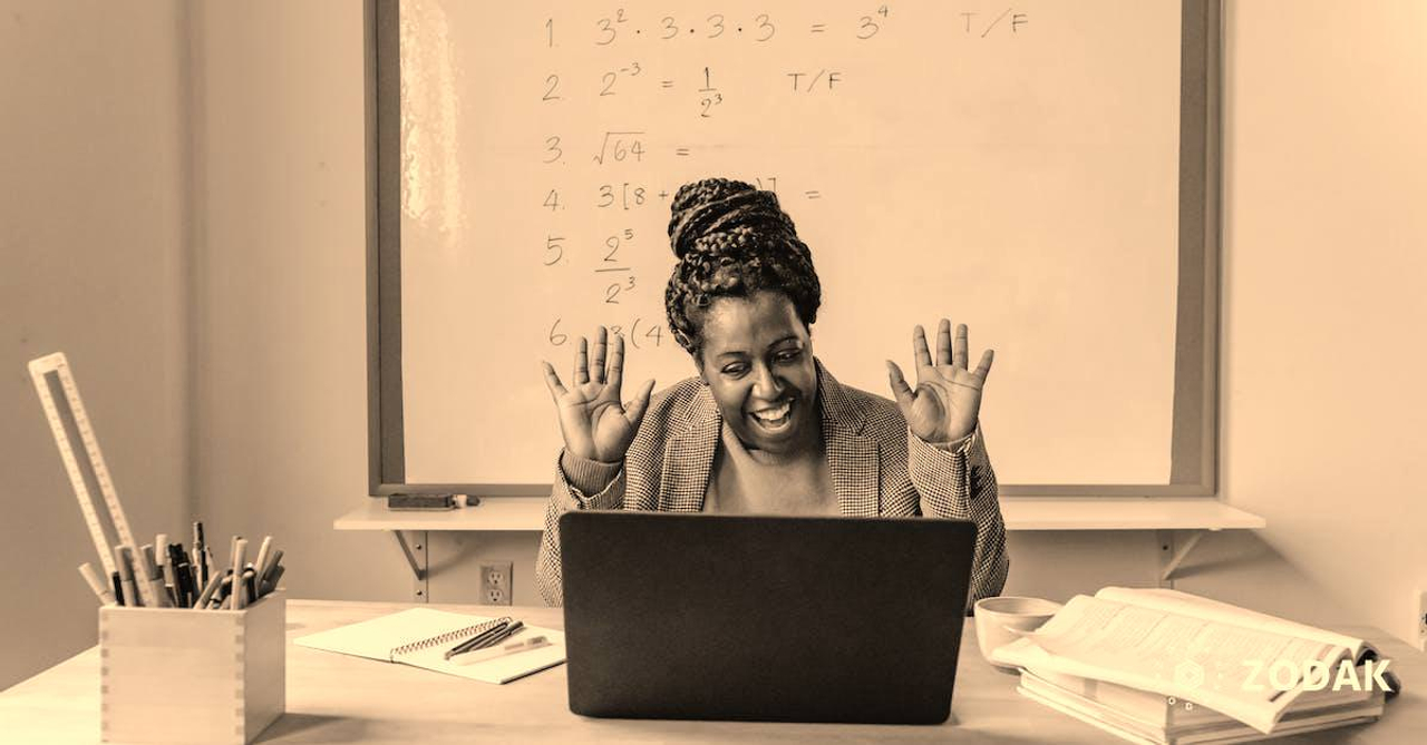 Happy black woman using laptop for online work