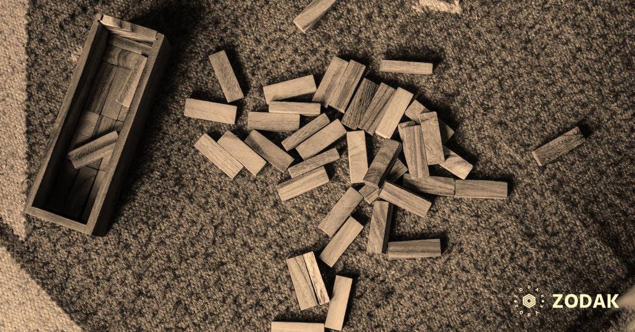 Top view of wooden box and pile of blocks for playing in jenga tower game arranged on floor carpet