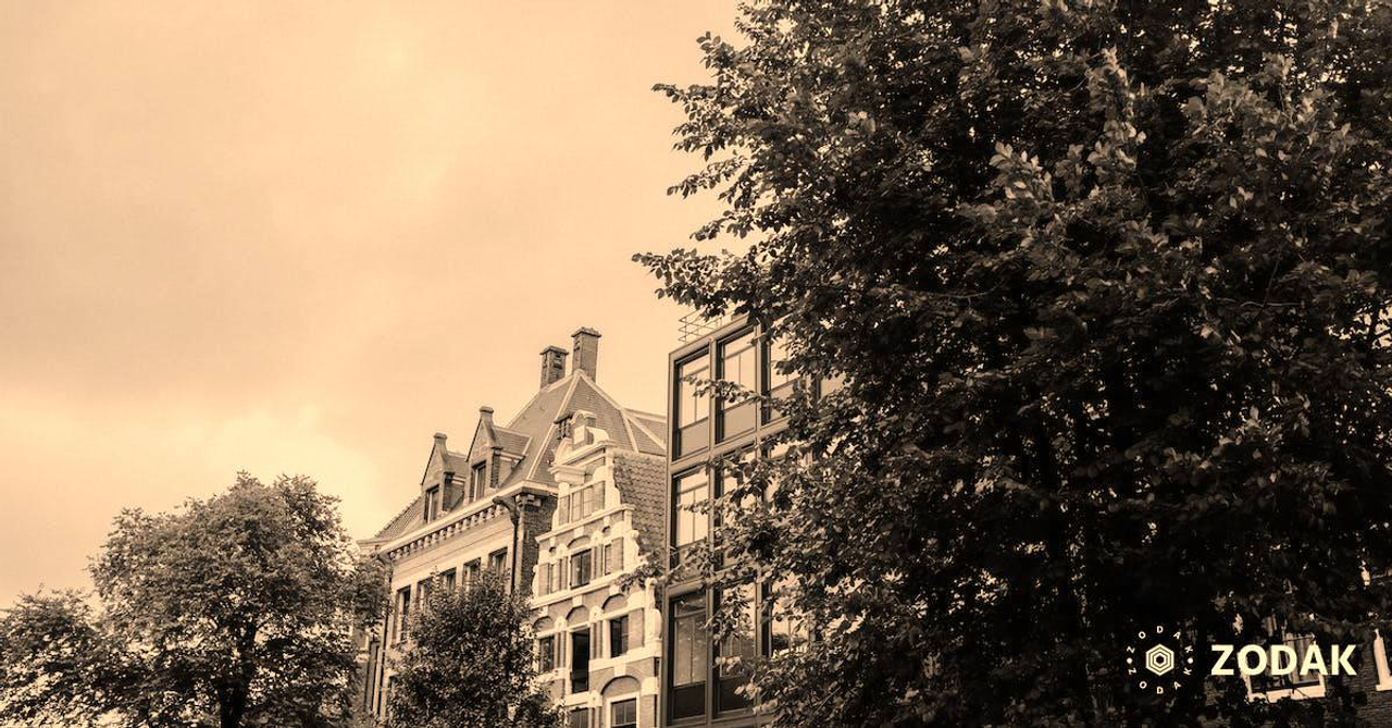 Exteriors of various residential buildings against cloudy sky