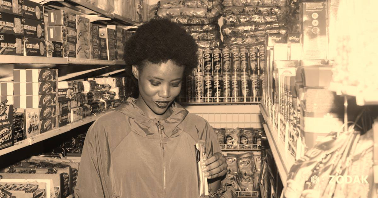 Positive ethnic woman choosing food in grocery store