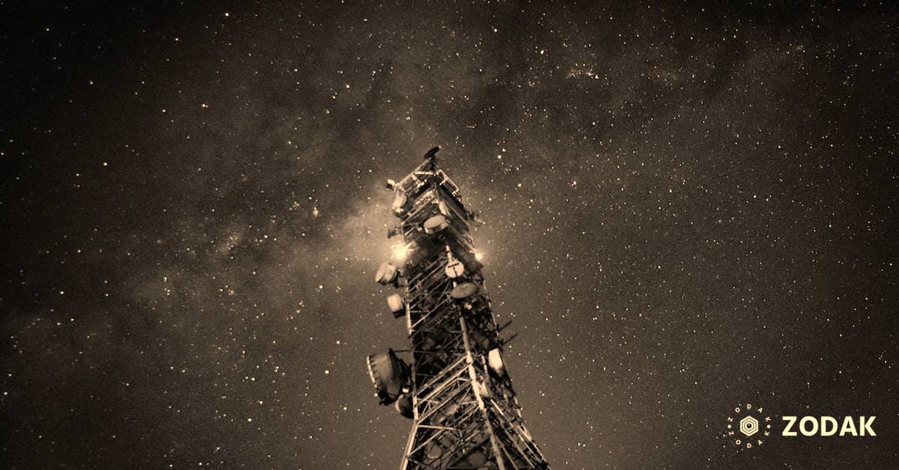 Transmission tower under starry night sky